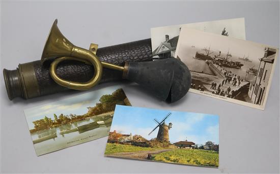 A quantity of postcards, a brass horn and a telescope